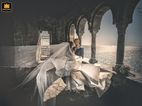 At Portovenere San Pietro, an artistic couple's portrait captures the view of the water through old-world stone arches.